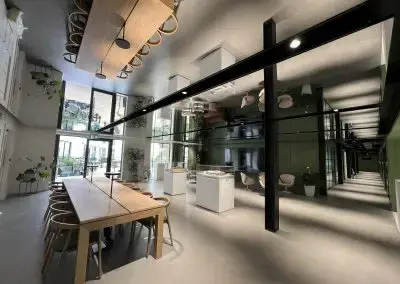 Large architectural mirror panels installed in a modern office, enhancing light, depth, and contemporary interior design.