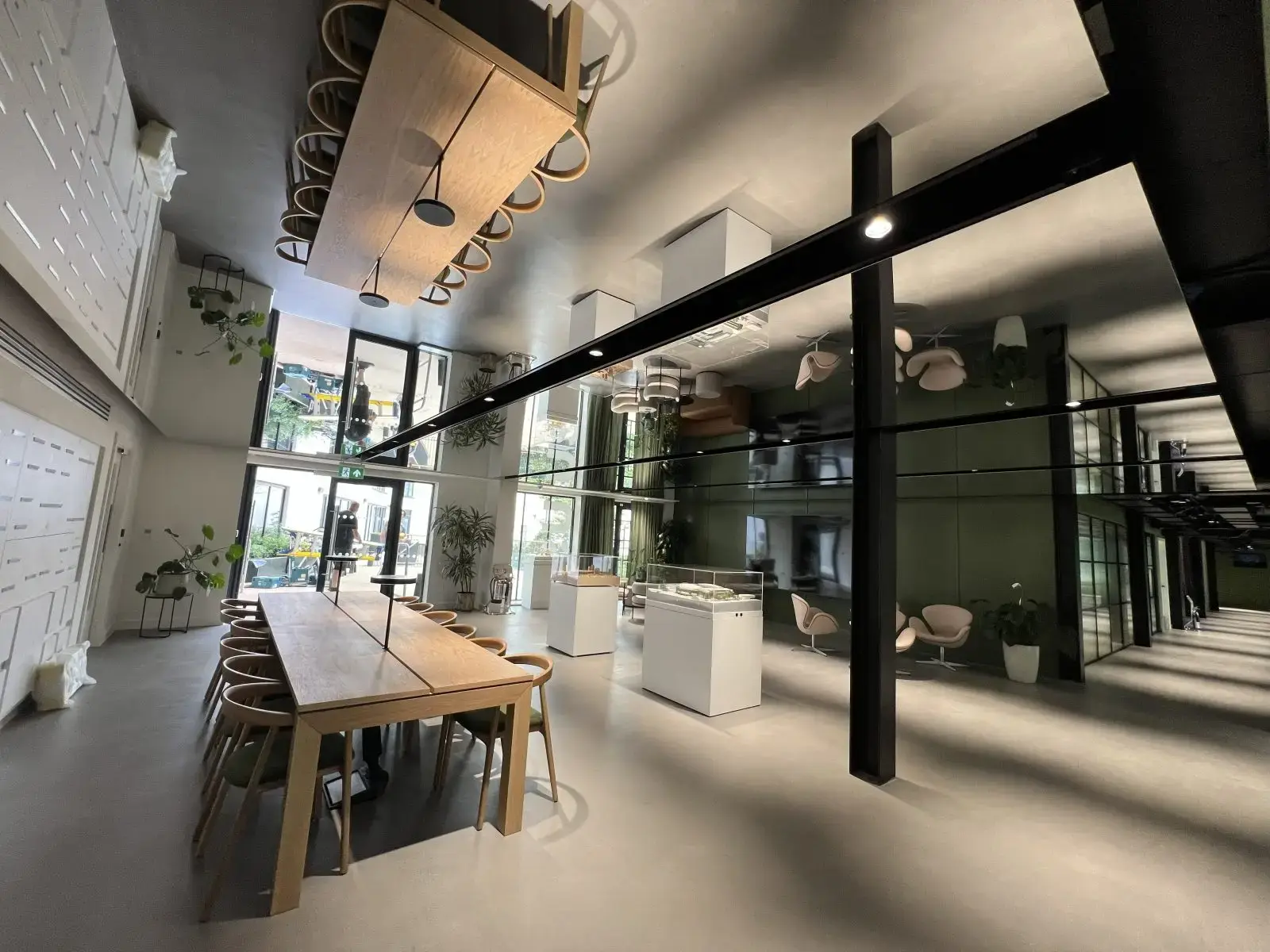 Fire-rated mirror film ceiling panels creating a reflective finish in a commercial office